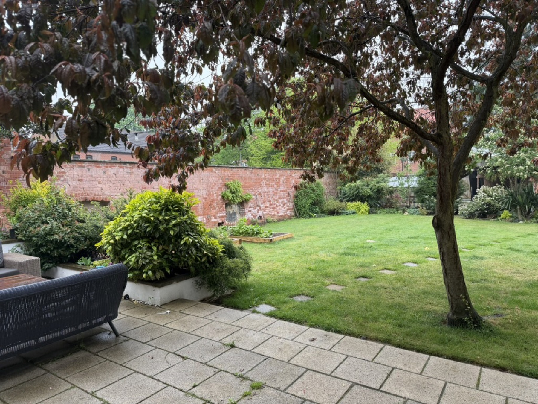 The lawn, the stepping stones, the old brick wall