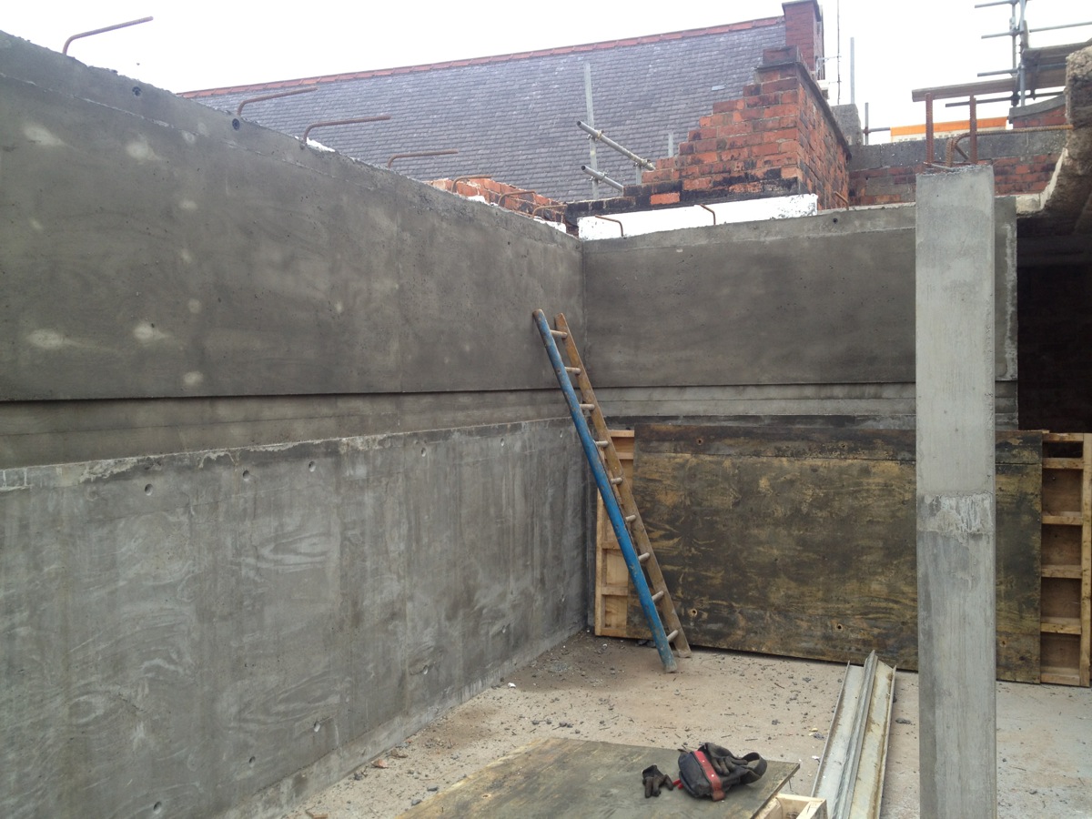 The bedroom and en suite wall and fireplace